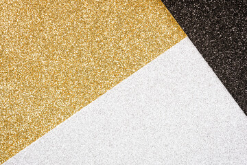 Luxury festive glitter background - abstract geometric composition in golden, black and silver colours with copy space for your text. Minimal fashionable style backdrop