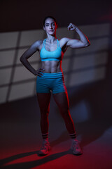 Fototapeta na wymiar Fitness model woman, dramatic lighting shot