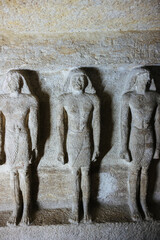 Ancient Egyptian statues in a tomb next the pyramids of Giza in Cairo, Egypt