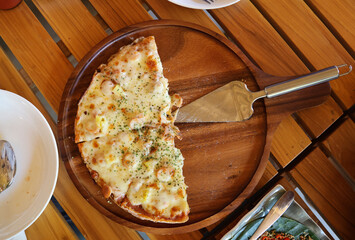 Half of Hawaiian pizza on wooden plate Italian pizza nice time to enjoy and party together