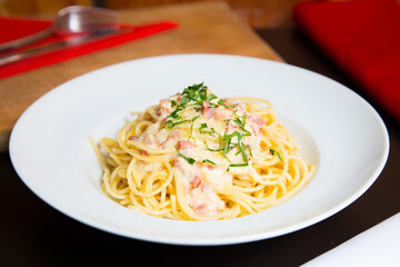Carbonara pasta. Carbonara is an Italian pasta dish from Rome made with eggs, hard cheese, cured pork, and black pepper.