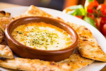 Provoleta. Provolone is an Italian cheese. It is an aged pasta filada cheese originating from Campania, near Vesuvius.