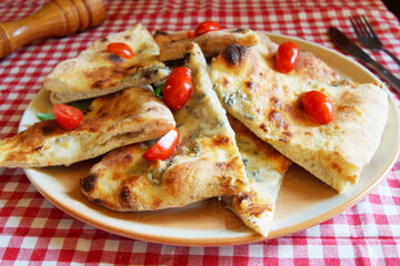 Focaccia is a kind of flat bread covered with herbs and other food products. It is a traditional Italian dish closely related to the popular pizza.