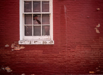Red brick wall and white broken window in chinatown, NYC