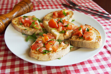 Bruschetta is an antipasto from Italy consisting of grilled bread rubbed with garlic and topped with olive oil and salt.