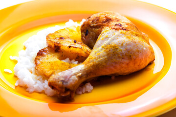 grilled chicken leg served with fried pineapple slices and rice