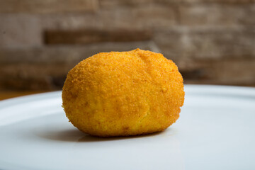Arancini are a specialty of Sicilian cuisine. They are stuffed breaded and fried rice balls or cones.