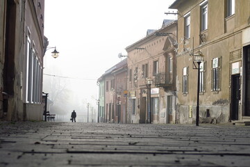 villiage and city center street of kremnica in slovakia in winter with fog