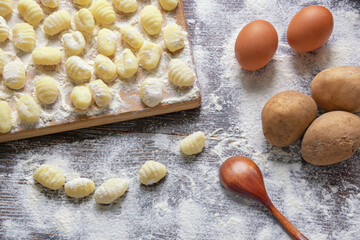 Balkan cuisine. Njoke ( gnocchi , potato dumpling ) on wooden cutting board