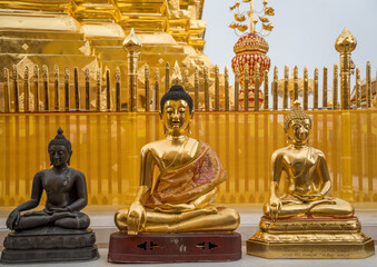 2 golden Buddha statues and 1 bronze Buddha statue