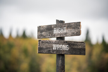 vintage and rustic wooden signpost with the weathered text quote right wrong, outdoors in nature....