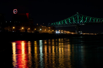 Fototapeta na wymiar Montreal Jacques Cartier Bridge night view at Old Port with Saint Lawrence River city light reflections outdoor nightscape.