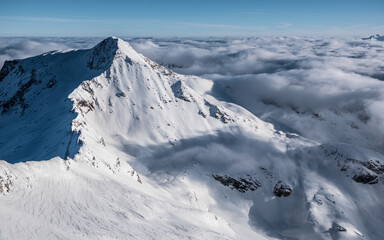 Fototapeta na wymiar Hinter Tux glacier mountain tops higher than clouds in Austrian Alps