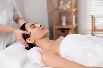 Obraz na płótnie Canvas Beautiful woman receiving massage in beauty salon, closeup