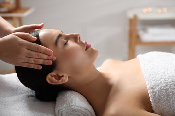 Beautiful woman receiving massage in beauty salon, closeup