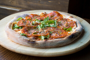 Salami Pizza. Neapolitan pizza made with salami, cheese and baked vegetables. Italian recipe.