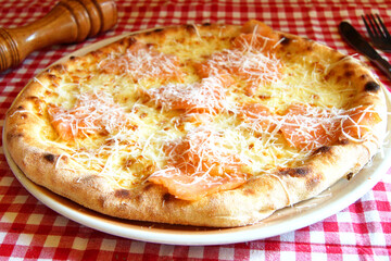 Salmon Pizza. Neapolitan pizza made with salmon and baked vegetables. Italian vegetarian recipe.