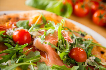 Salmon Pizza. Neapolitan pizza made with salmon and baked vegetables. Italian vegetarian recipe.
