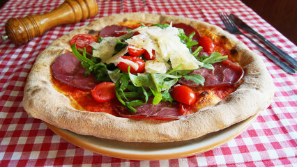 Serrano ham pizza. Neapolitan pizza made with baked vegetables and serrano ham. Italian recipe.