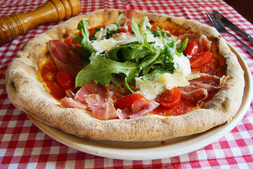 Serrano ham pizza. Neapolitan pizza made with baked vegetables and serrano ham. Italian recipe.