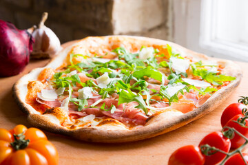 Serrano ham pizza. Neapolitan pizza made with baked vegetables and serrano ham. Italian recipe.