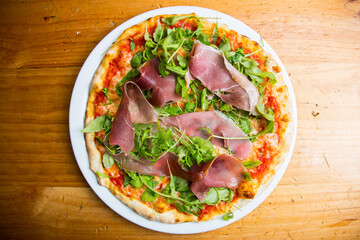 Serrano ham pizza. Neapolitan pizza made with baked vegetables and serrano ham. Italian recipe.