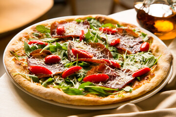 Serrano ham pizza. Neapolitan pizza made with baked vegetables and serrano ham. Italian recipe.