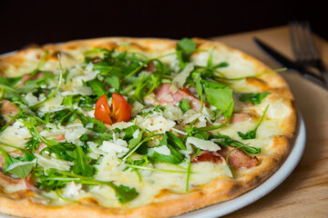 Serrano ham pizza. Neapolitan pizza made with baked vegetables and serrano ham. Italian recipe.