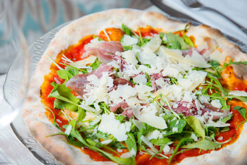 Serrano ham pizza. Neapolitan pizza made with baked vegetables and serrano ham. Italian recipe.