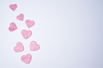 Glittering pink hearts on white background. Valentines day concept. Womans day. Copy space. Flat lay.
