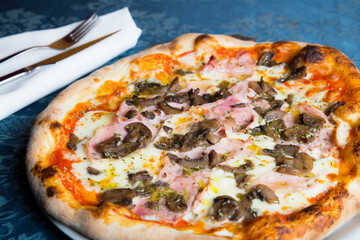 Mushroom Pizza. Neapolitan pizza with tomato sauce, cheese, ham and mushrooms. Authentic Italian recipe.
