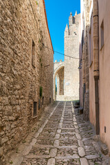 Fototapeta premium The small town of Erice with its stone houses and narrow, picturesque streets and alleys on the Mount Erice in the west of Sicily. The alley leads to the Chiesa Madre, the Cathedral of Erice