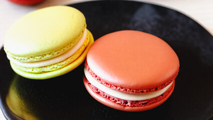 close up shot of macaron on black plate
