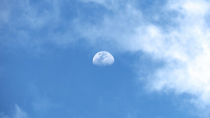 Naklejka na ściany i meble Stunning view of the moon during the day