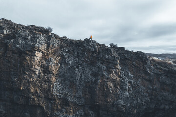 Professional mountain climber posing at the peak of mountain