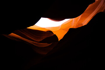 high contrast between dark sandstone walls and daylight in antelope canyon