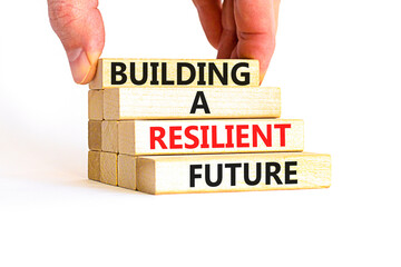 Building a resilient future symbol. Concept word Building a resilient future on wooden blocks. Beautiful white table white background. Business and building a resilient future concept. Copy space.