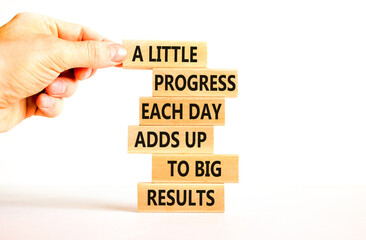 Progress and result symbol. Concept words A little progress each day adds up to big results on wooden blocks on a beautiful white background. Businessman hand. Business future in your hands concept.