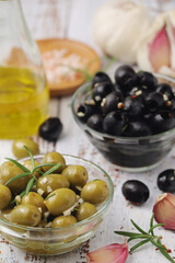 Black and green olives in glass bowls	