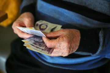 old man counting money close up of hands