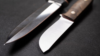 Blade of a large hunting knife close-up isolated on a black background