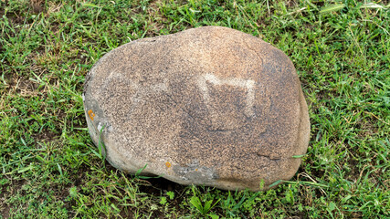 Petroglyph in Kyrgyzstan. An ancient rock carving and engraving known as petroglyphs created by...