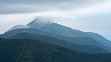 Fototapeta na wymiar Foggy landscape of mountains. The peaks of the Chornohora mountain range (Ukrainian Carpathians).