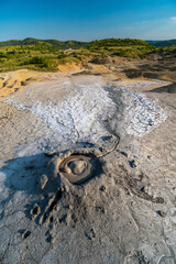 Mud volcano with gas bubble, muddy wet geology, lunar landscape, Berca, Romania