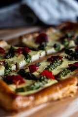 Asparagus tart with a ricotta/egg/dill base on puff pastry,  garnished with nasturtium petals