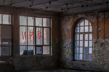 Fototapeta na wymiar Old abandoned haunted red brick factory of stockings, pantyhose and socks in Central Europe, Poland