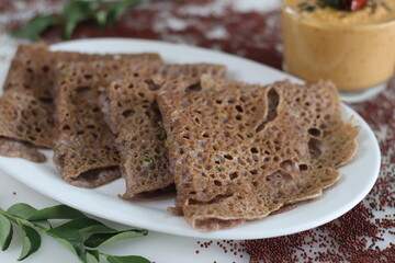 Instant Finger Millet Dosa, made with finger millet flour, curd and spices. Served with coconut chilly condiment.