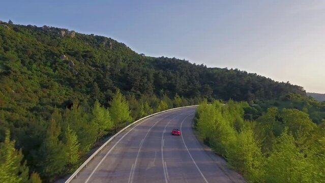 drone tracking of the red car on the forest road