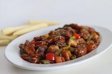 Chilly paneer with baby corn. An Indo Chinese dish made with cubes of paneer with baby corn, bell peppers, onions and a spicy sauce