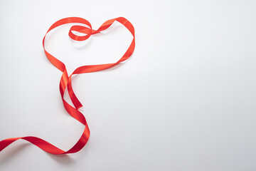 Heart made from red ribbon.